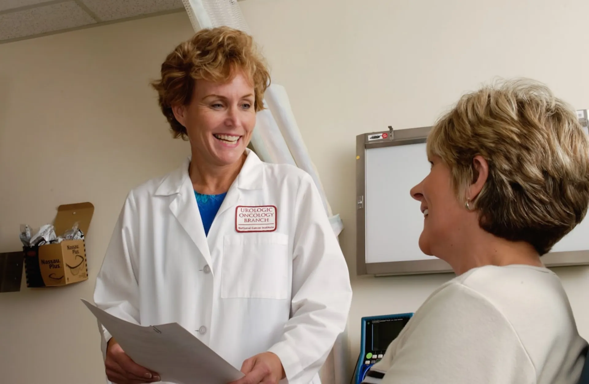 A consultant talking with a practice owner across a desk